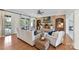 Comfortable living room with a brick fireplace, built-in shelves, and French doors at 7295 Three Sisters Ln, Concord, NC 28027