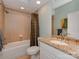 This bathroom features a tiled shower and tub, granite countertops, and neutral paint at 8015 Greenview Terrace Ct, Charlotte, NC 28277