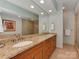 Bathroom with double sinks, a large mirror, and a glass-enclosed shower at 8015 Greenview Terrace Ct, Charlotte, NC 28277