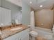 Bathroom featuring a granite countertop, vanity sink, and tiled shower at 8015 Greenview Terrace Ct, Charlotte, NC 28277