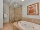 Bathroom featuring a soaking tub and a glass shower at 8015 Greenview Terrace Ct, Charlotte, NC 28277