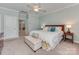 Bedroom with a ceiling fan, neutral walls, and a comfortable upholstered bench at 8015 Greenview Terrace Ct, Charlotte, NC 28277