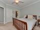 This primary bedroom offers a neutral color palette, ceiling fan and ensuite bathroom at 8015 Greenview Terrace Ct, Charlotte, NC 28277
