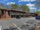 Well-maintained two-story commercial brick building with parking spaces and mature landscaping at 8015 Greenview Terrace Ct, Charlotte, NC 28277