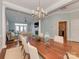 Dining room with wooden table and modern chairs open to a living room with fireplace at 8015 Greenview Terrace Ct, Charlotte, NC 28277
