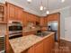 Gourmet kitchen showcases stainless appliances, granite countertops, and custom wood cabinetry throughout at 8015 Greenview Terrace Ct, Charlotte, NC 28277