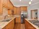 The expansive kitchen has stainless steel appliances, wood cabinetry, and a granite island at 8015 Greenview Terrace Ct, Charlotte, NC 28277