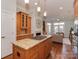 Open kitchen to living room area has wood cabinets, a gas range island, and recessed lights at 8015 Greenview Terrace Ct, Charlotte, NC 28277