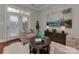 Comfortable living room is designed with bright decor, access to the patio, and calming artwork at 8015 Greenview Terrace Ct, Charlotte, NC 28277