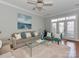 Comfortable living room with a plush rug, sofa with pillows, and French doors to a patio at 8015 Greenview Terrace Ct, Charlotte, NC 28277