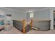 Open staircase with wood and iron railing leading upstairs with a window for natural light at 8015 Greenview Terrace Ct, Charlotte, NC 28277