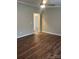 Spacious bedroom showcasing hardwood floors and natural light from a doorway at 8502 Simpson Rd, Waxhaw, NC 28173