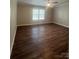 Bright bedroom showcasing hardwood floors and natural light from a large window at 8502 Simpson Rd, Waxhaw, NC 28173