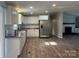 Beautiful kitchen with stainless steel appliances and adjacent living space featuring a fireplace at 8502 Simpson Rd, Waxhaw, NC 28173