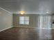 Spacious living room features hardwood floors, window, and recessed lighting at 8502 Simpson Rd, Waxhaw, NC 28173