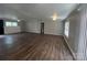 Large living room with wood floors and a ceiling fan, creating a cozy atmosphere at 8502 Simpson Rd, Waxhaw, NC 28173