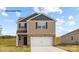 Charming two-story home featuring a two-car garage and a combination of brick and siding exterior at 882 Two Brothers Ln, York, SC 29745