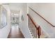 Inviting hallway featuring hardwood floors, staircase with wood railing and wrought iron spindles at 882 Two Brothers Ln, York, SC 29745