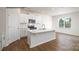 Modern kitchen with white cabinets, stainless steel appliances, granite counters and hardwood floors at 882 Two Brothers Ln, York, SC 29745