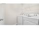Bright laundry room with white washer, dryer and wire shelving for organized storage at 882 Two Brothers Ln, York, SC 29745