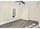 Bedroom with wood-look flooring and a large window at 1132 E Main St, Albemarle, NC 28001