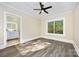 Relaxing bedroom with ensuite bathroom, natural light, and modern wood-look floors at 1132 E Main St, Albemarle, NC 28001