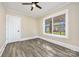 Bedroom with hardwood floors, a ceiling fan, and a window with neighborhood views at 1132 E Main St, Albemarle, NC 28001