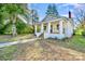 Inviting exterior showcasing a white brick home with a front porch and manicured lawn at 1132 E Main St, Albemarle, NC 28001