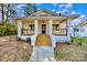 Charming brick home with inviting front porch, classic columns, and neat landscaping at 1132 E Main St, Albemarle, NC 28001