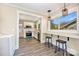 Open kitchen layout with eat-in counter, stainless appliances, and a view to the laundry area at 1132 E Main St, Albemarle, NC 28001