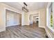 Spacious living room featuring gray flooring and a clear view into the kitchen and hallway at 1132 E Main St, Albemarle, NC 28001