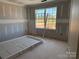 New bedroom with a large window and a view of the outdoors; door lying on the floor at 1259 Willow Grove Ln # 100, York, SC 29745