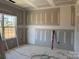 Bedroom with fresh drywall, a large window letting in natural light, and visible electrical outlets at 1259 Willow Grove Ln # 100, York, SC 29745