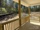 Covered porch with wooden railing overlooks wooded area, offering a tranquil outdoor space at 1259 Willow Grove Ln # 100, York, SC 29745