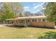 Charming single-story home featuring a covered porch overlooking a spacious backyard and landscaped greenery at 1747 Williams Cir, Lancaster, SC 29720