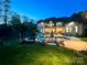 Expansive backyard featuring a sparkling pool, lush lawn, and mature trees, creating a serene outdoor oasis at 2017 Colorado Ct, Lancaster, SC 29720