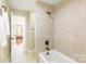 Bright bathroom featuring ceramic tiles, tub/shower, and a doorway leading to adjacent bedroom at 2017 Colorado Ct, Lancaster, SC 29720