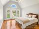 Bright bedroom with a high ceiling, large windows, and hardwood floors, creating a warm and inviting space at 2017 Colorado Ct, Lancaster, SC 29720