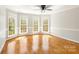 Bright bonus room has beautiful bay windows, hardwood floors, and light gray walls and trim at 2017 Colorado Ct, Lancaster, SC 29720
