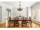 Elegant dining room with hardwood floors, chandelier, and large windows providing natural light at 2017 Colorado Ct, Lancaster, SC 29720