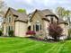 Beautiful home exterior with a stone facade, well-maintained lawn, and professionally landscaped garden beds at 2017 Colorado Ct, Lancaster, SC 29720