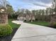 Charming home with a manicured lawn and a long driveway, flanked by stone pillars with lanterns at 2017 Colorado Ct, Lancaster, SC 29720