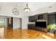 Cozy living room featuring custom cabinetry, a mini bar, hardwood floors, and large clock decor at 2017 Colorado Ct, Lancaster, SC 29720