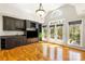Comfortable living space featuring custom cabinetry, a mini bar, hardwood floors, and natural light at 2017 Colorado Ct, Lancaster, SC 29720