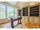 Bright home office with custom built-ins and large windows overlooking the manicured lawn at 2017 Colorado Ct, Lancaster, SC 29720
