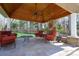 Covered outdoor living area with stone fireplace, seating and ceiling fan, perfect for entertaining at 2017 Colorado Ct, Lancaster, SC 29720