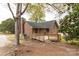 Brick home features a spacious deck ideal for outdoor gatherings, complemented by lush green trees at 2220 Ross Cauthen Rd, Lancaster, SC 29720