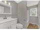 Bright bathroom with single vanity, tub and shower combo, and modern fixtures at 2220 Ross Cauthen Rd, Lancaster, SC 29720