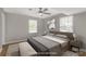 Modern bedroom with a neutral color palette, featuring a large bed, bench, and a ceiling fan at 2220 Ross Cauthen Rd, Lancaster, SC 29720