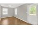 Bright bedroom features wood floors, neutral walls, and two windows, providing an airy and comfortable space at 2220 Ross Cauthen Rd, Lancaster, SC 29720